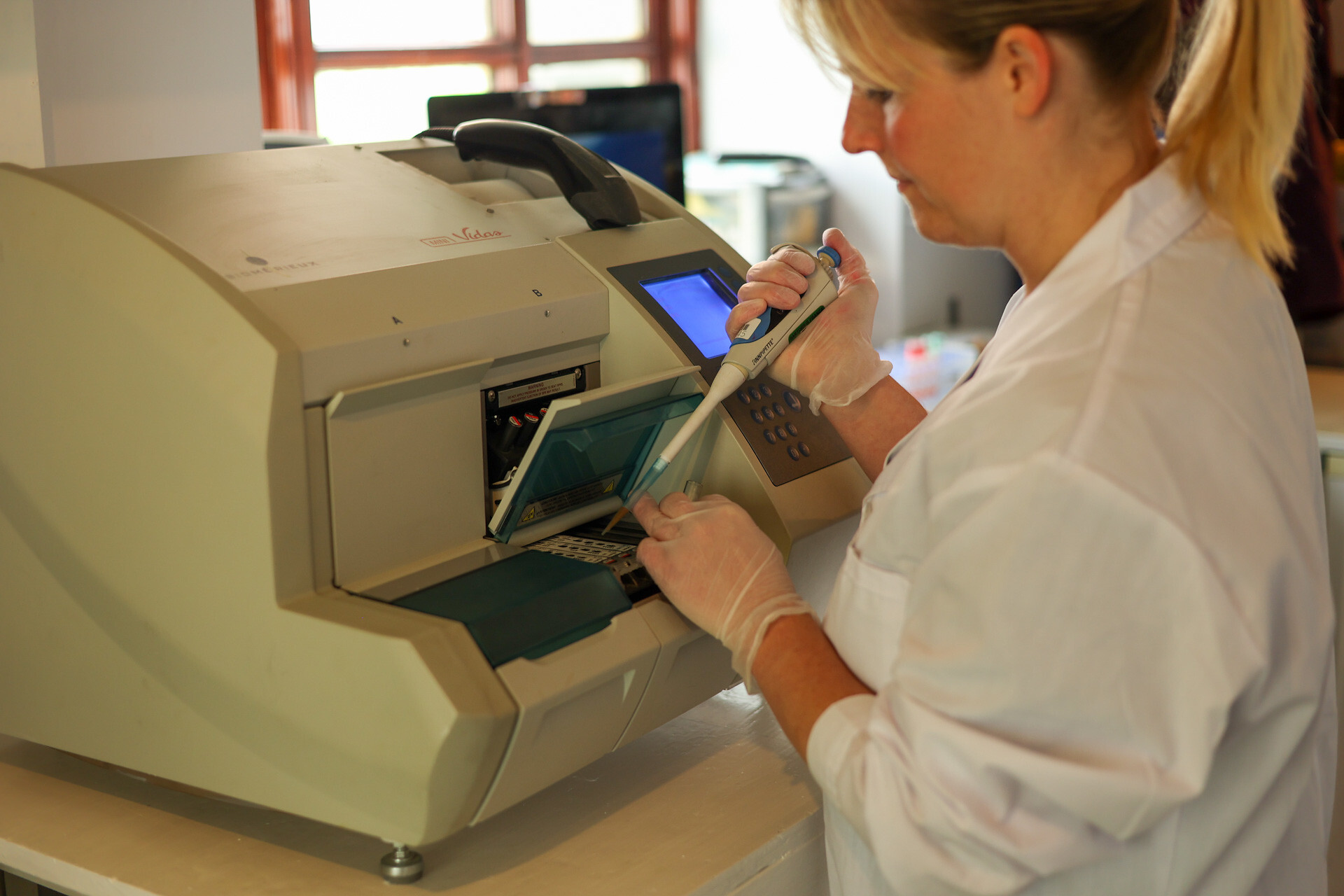 Dragon Lab expert using allergy testing machine.